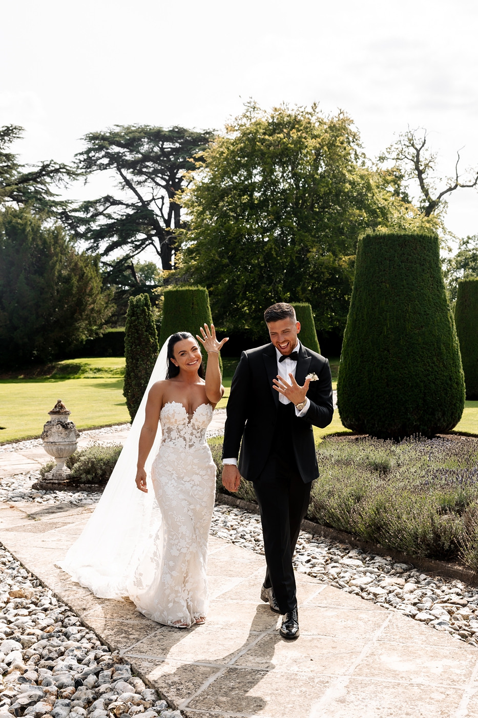 A timeless candid moment captured at a Hengrave Hall wedding. Perfect inspiration for couples dreaming of an elegant garden celebration with fine art, editorial-style wedding photography