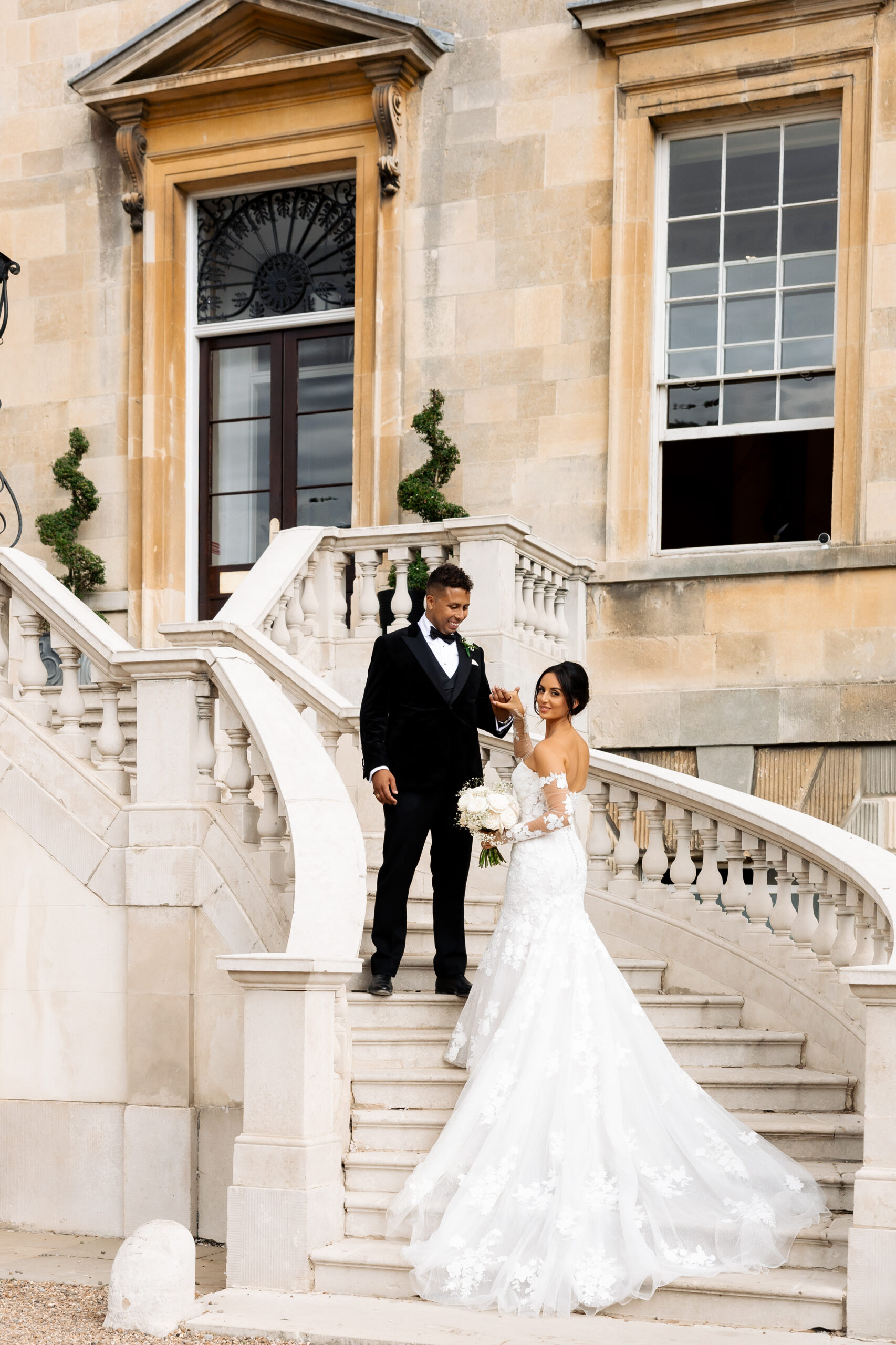 Bride and groom portraits on outdoor staircase at Botleys Mansion